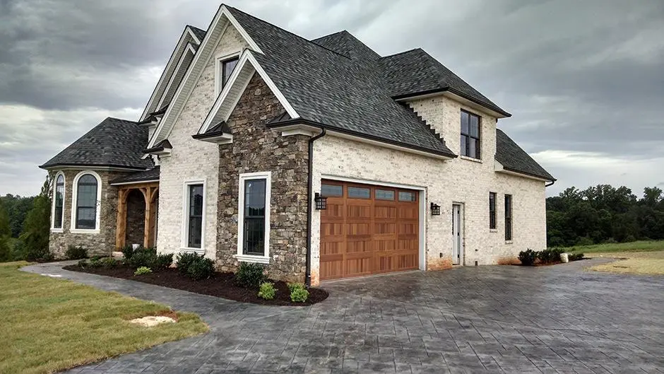 Stone home with a custom wood-look garage door