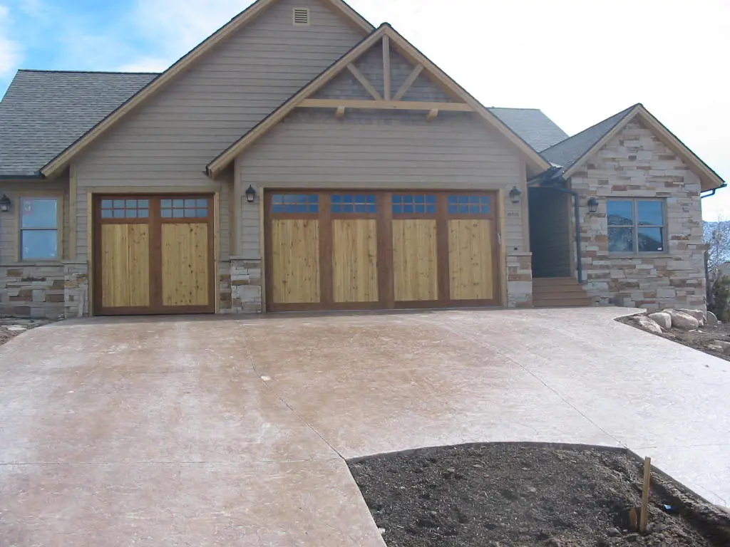 Wood and glass garage doors on a new construction home